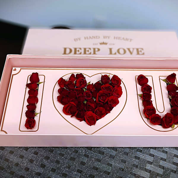 Pink gift box with red roses arranged as "I love U"