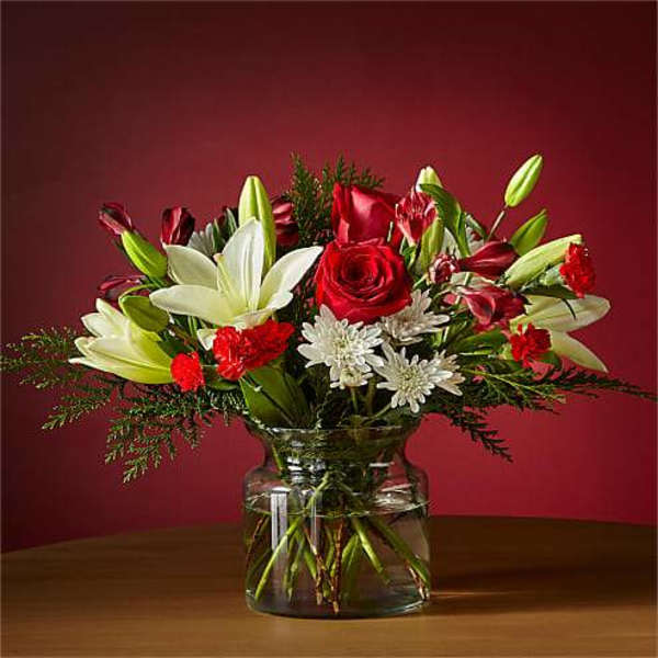 Bouquet of red roses and white lilies in a glass vase