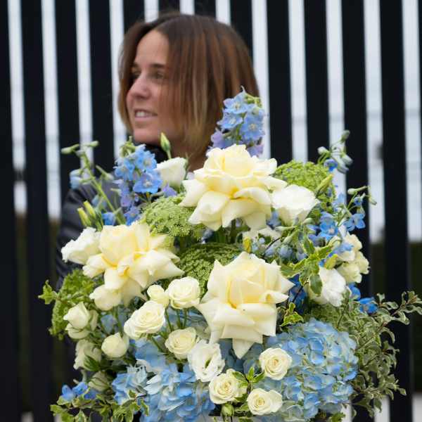 Large blue and white floral arrangement in a white box with ribbon