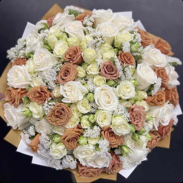 Bouquet of white and peach roses with small white filler flowers