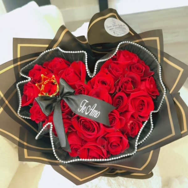Bouquet of red roses wrapped in black paper with a ribbon
