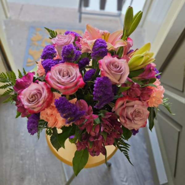 Bouquet of pink roses, lilies, and purple flowers