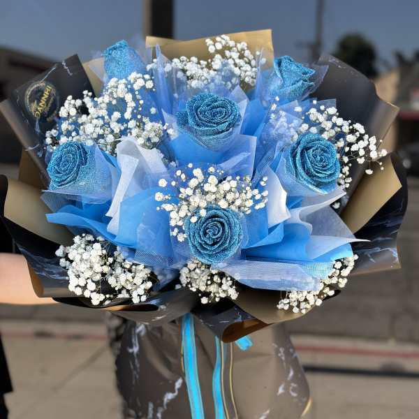 Bouquet of blue roses with white baby's breath and black wrapping