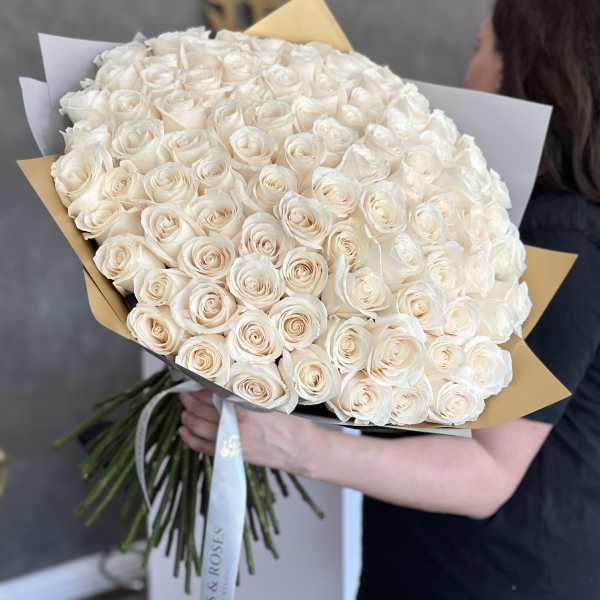 Large bouquet of cream roses wrapped in paper