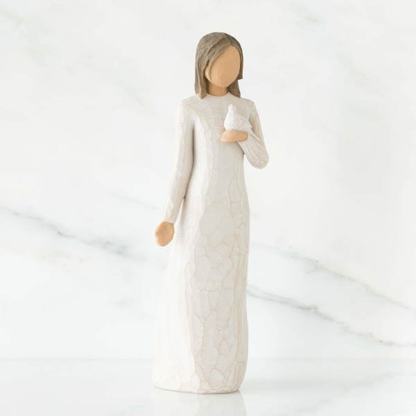 Figurine of a girl in a white dress holding a small white bird