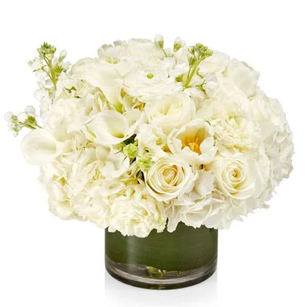 White floral arrangement in a green glass vase