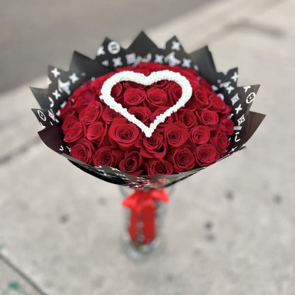 Bouquet of red roses with a white heart accent in black wrap