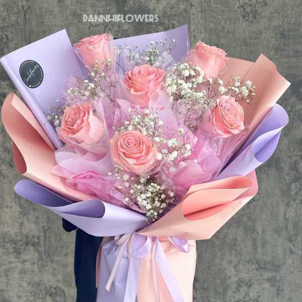 Pink roses with baby's breath in pastel lavender and peach wrapping