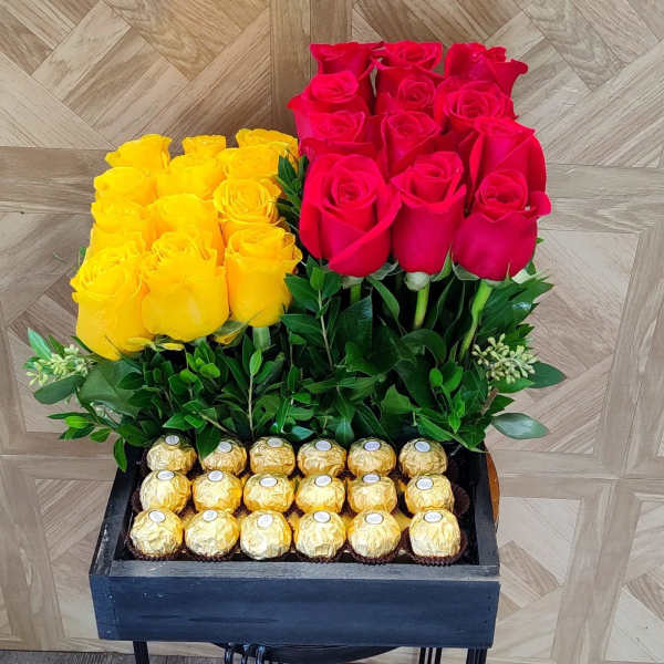 Yellow and red roses in a black box with gold chocolates