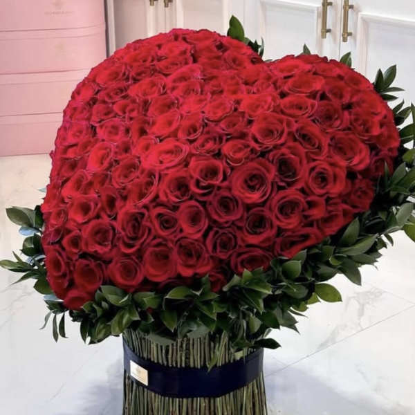 Large dome bouquet of red roses with greenery at the base