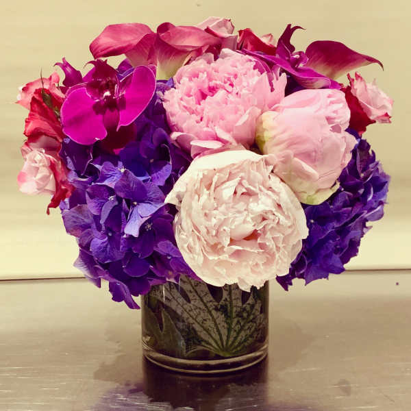 Pink and purple floral arrangement in a glass vase