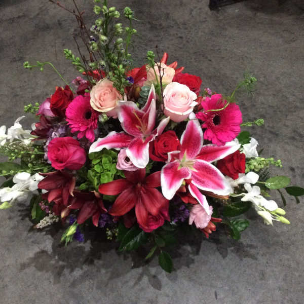 Mixed bouquet with pink and red roses, lilies, and gerbera daisies