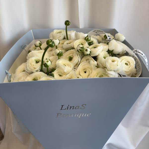 White ranunculus bouquet in a light blue box