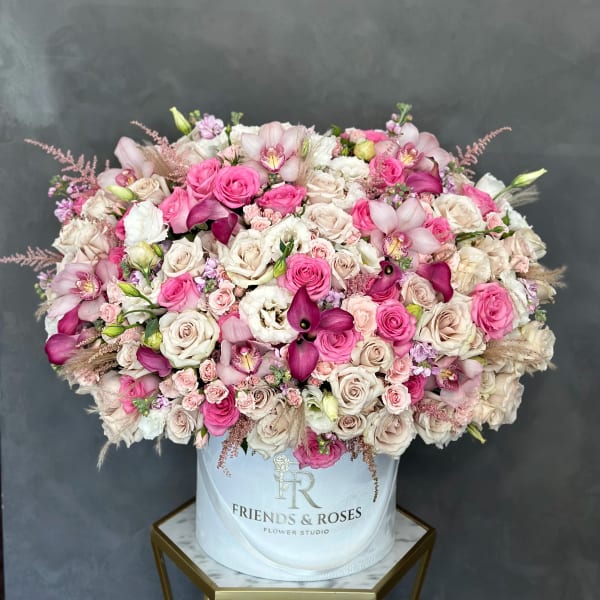 Large pink and cream rose arrangement in a white hat box
