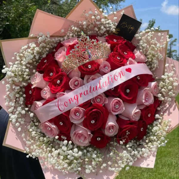 Bouquet of red and pink roses with a crown and congratulation ribbon