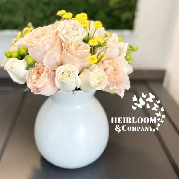 Blush and white rose bouquet in a white vase