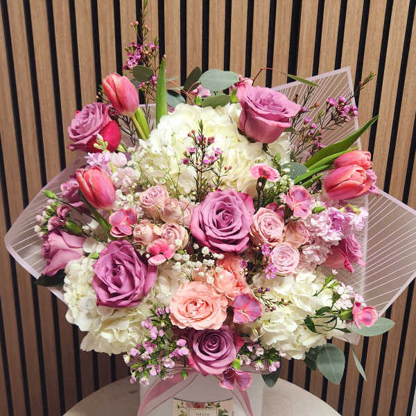 Pink and white bouquet in a white hat box with ribbon