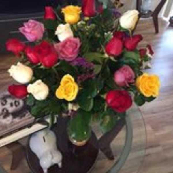 Bouquet of multicolored roses in a glass vase