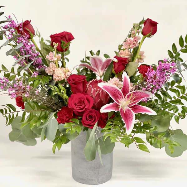Red roses and pink lilies in a gray vase