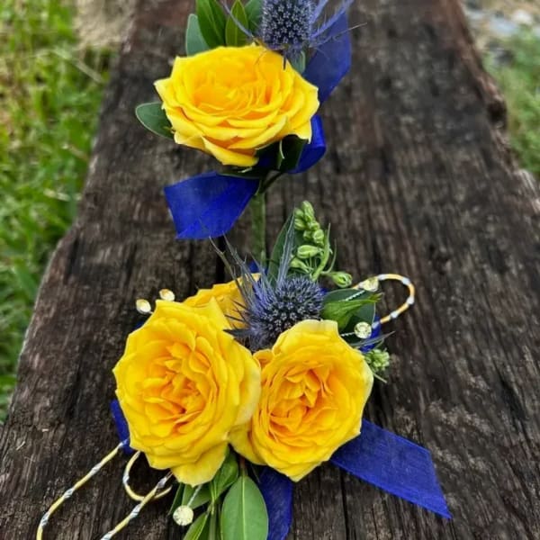 Yellow rose corsage and boutonniere with blue ribbon accents
