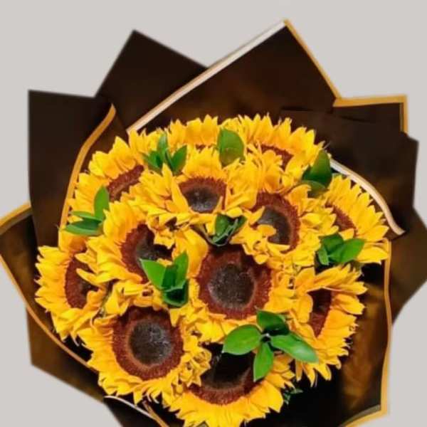 Bouquet of sunflowers wrapped in dark brown paper