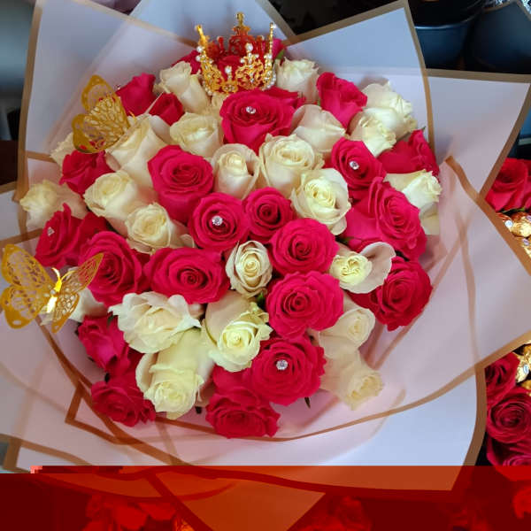 Bouquet of pink and white roses with gold butterfly picks