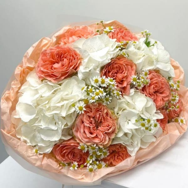 Peach roses and white hydrangeas in peach wrapping