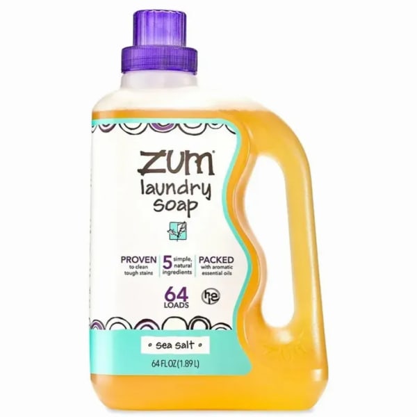 Bottle of Zum laundry soap with a purple cap and yellow liquid