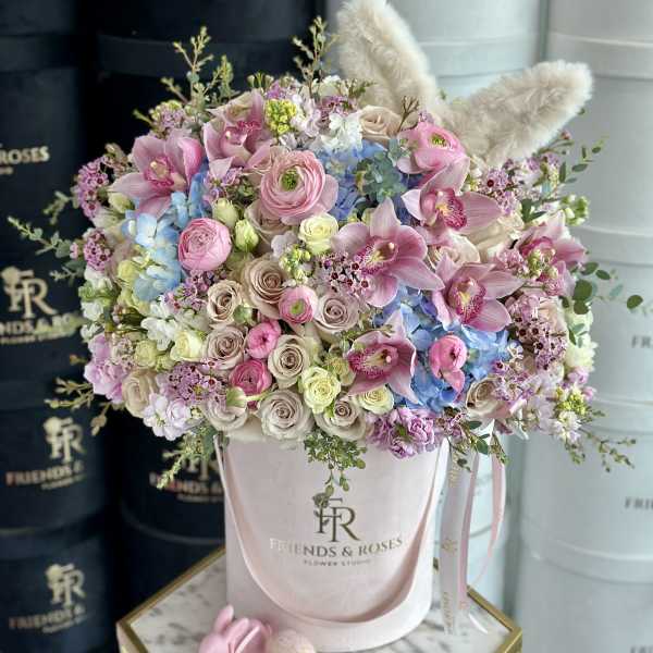 Pastel bouquet in a pink hatbox with plush bunny ears