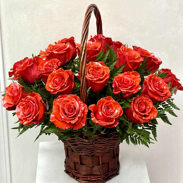 Basket of red roses with greenery