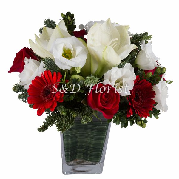 Red and white flowers arranged in a square glass vase