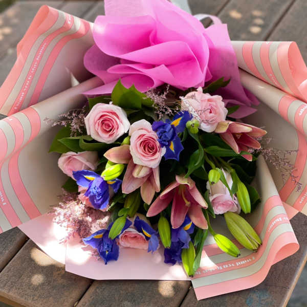 Pink and blue mixed bouquet wrapped in pink paper