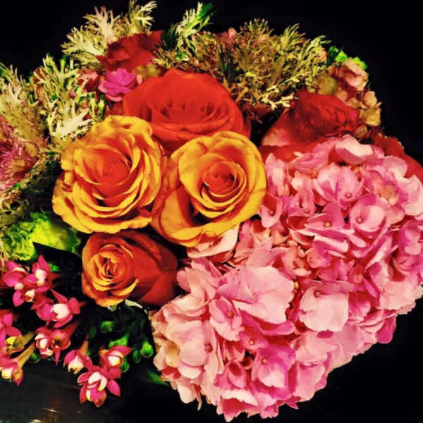 Bouquet of orange roses and pink hydrangeas with mixed filler flowers