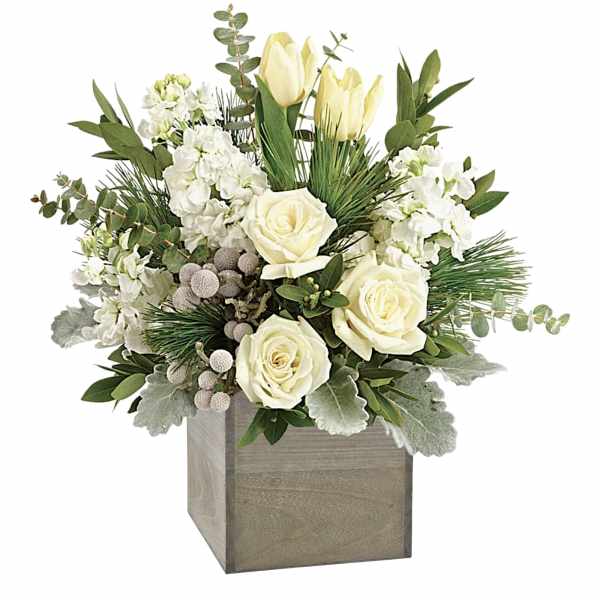 White roses and pale tulips in a wooden cube vase