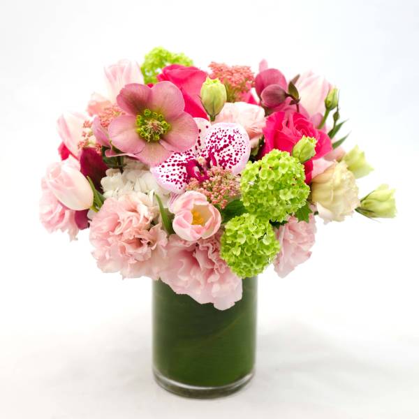 Pink and white mixed bouquet in a tall glass vase