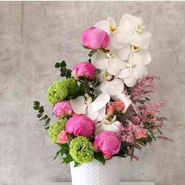 Pink and white floral arrangement in a white vase