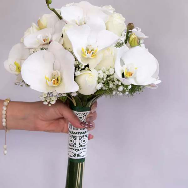 White orchid bouquet with lace-wrapped handle