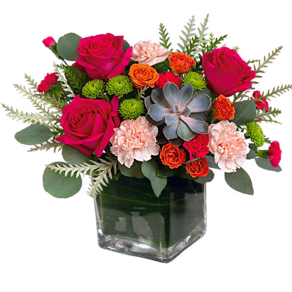 Bouquet of pink roses and carnations in a square glass vase