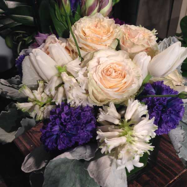 Bouquet of cream roses, white lilies, and purple flowers