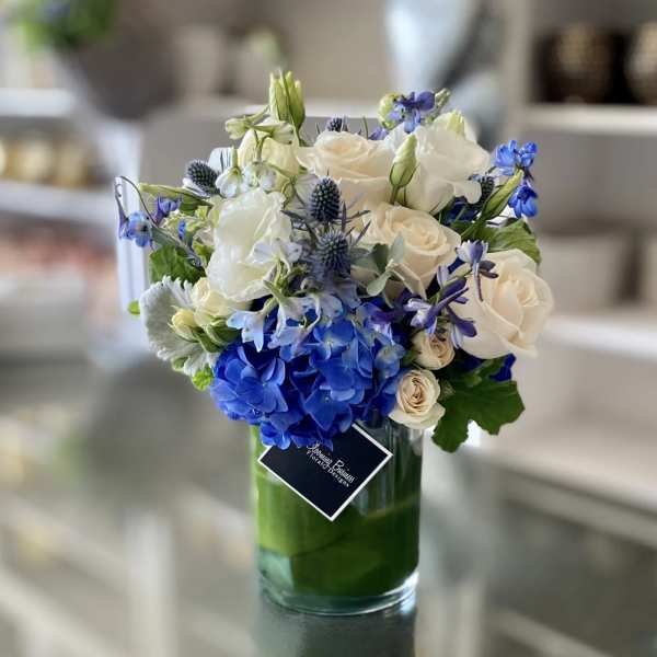Blue and white bouquet in a clear glass vase