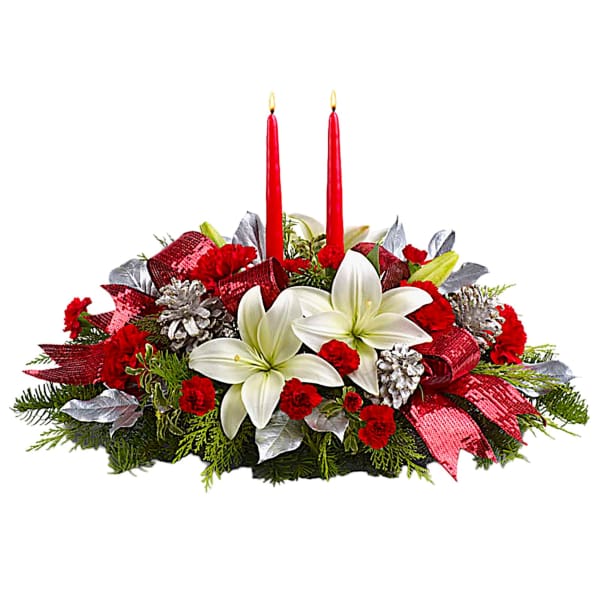 Holiday centerpiece with white lilies, red carnations, and two red candles