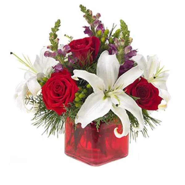 Red roses and white lilies in a red glass vase