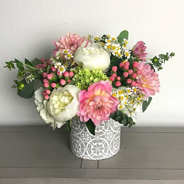 Pink and white mixed bouquet in a patterned round box