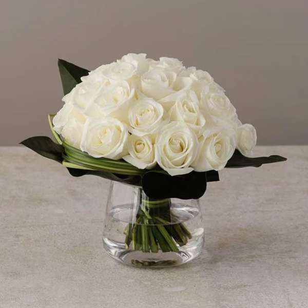 White rose bouquet in a clear glass vase