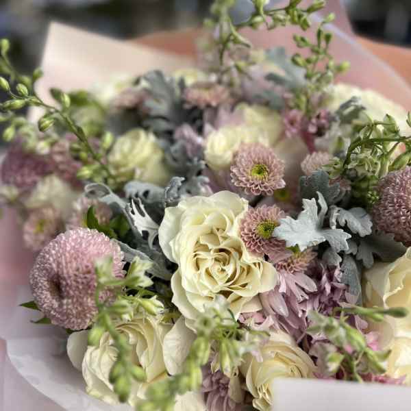 Bouquet of cream roses and pink chrysanthemums with silvery foliage