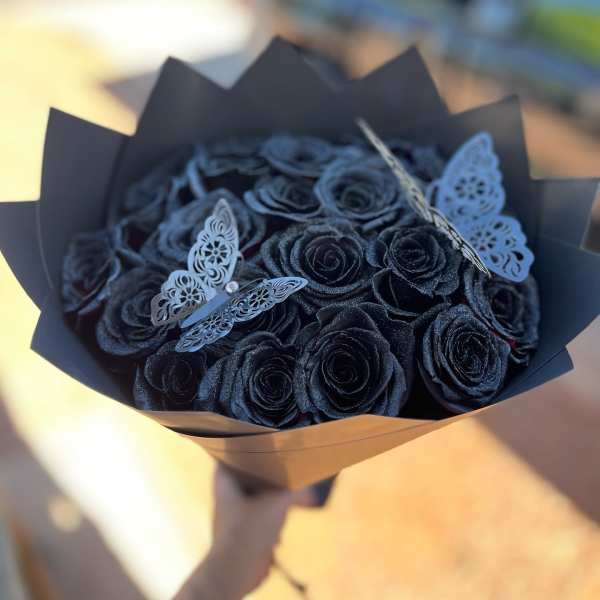Bouquet of black roses with decorative butterfly accents