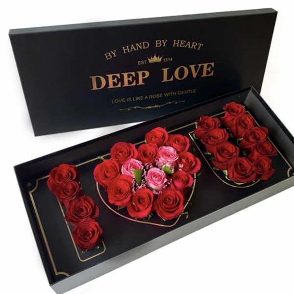 Black gift box with red and pink roses arranged in a heart shape