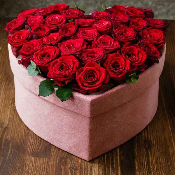 Heart-shaped box filled with red roses