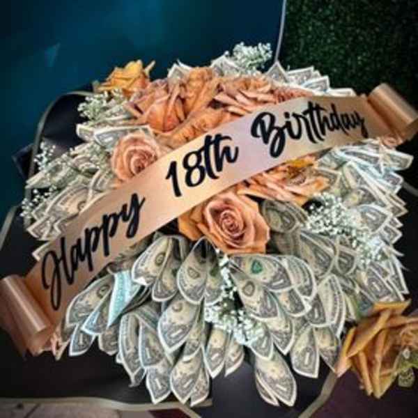 Money bouquet with peach roses and a birthday ribbon