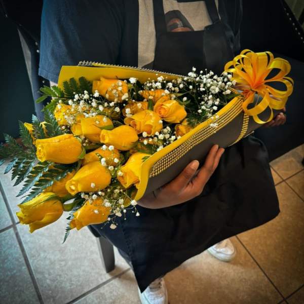 Bouquet of yellow roses with baby's breath in a decorated wrap